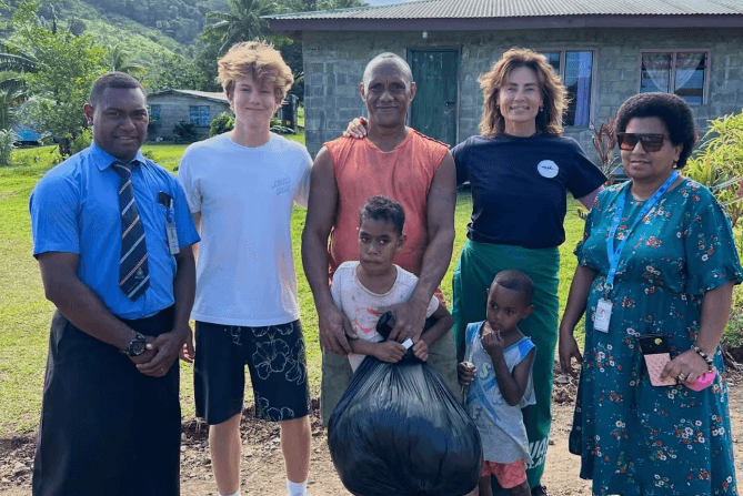 OOCSA volunteers and community members delivering a package in Fiji