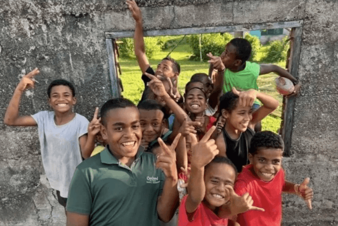 A joyful group of children gathered together in Fiji