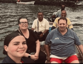 George, Katherine, and Katrina with OOCSA community members in a canoe